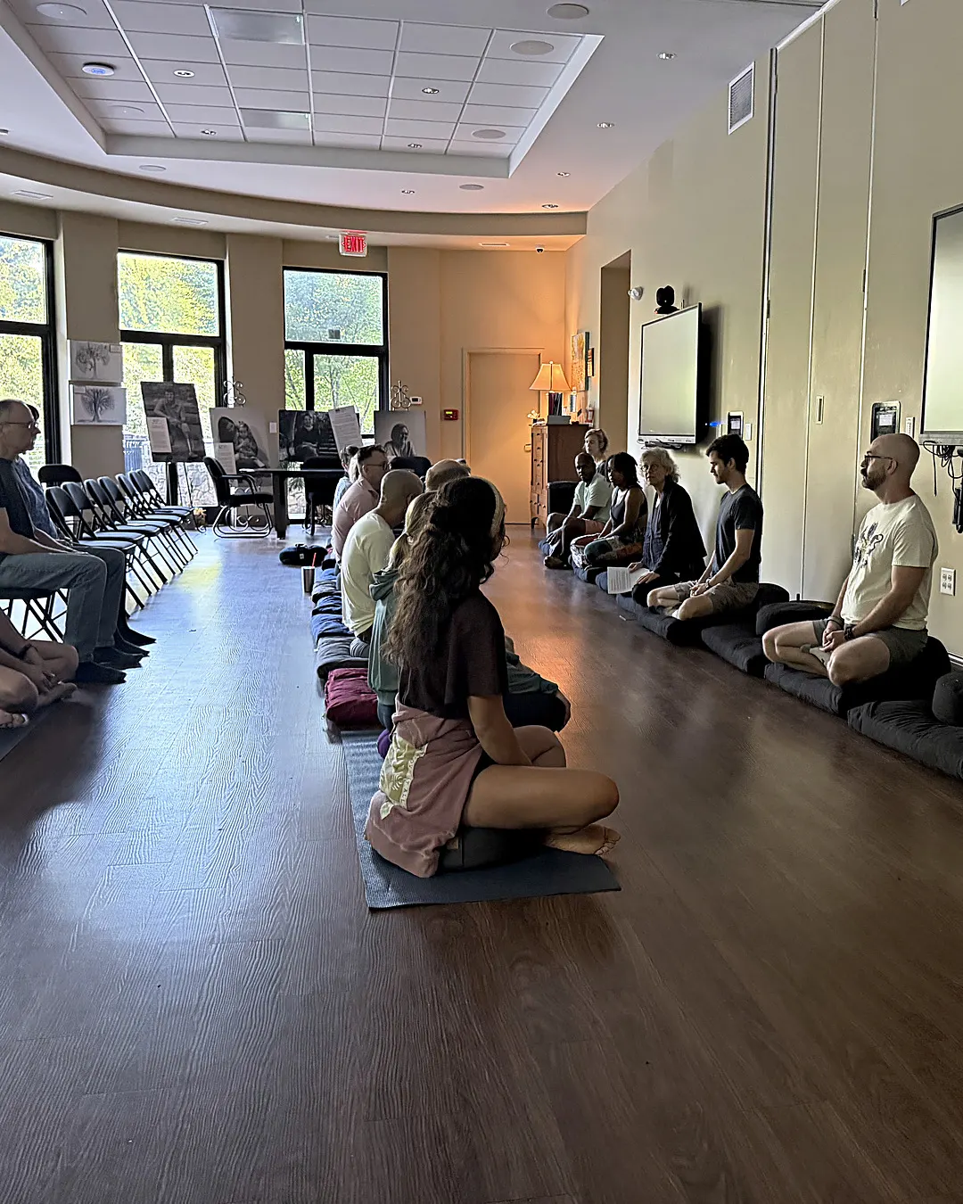 Practitioners sitting zazen together along the wall of the meditation hall on a Sunday morning at Cancer Survivors Park Center for Hope & Healing.
