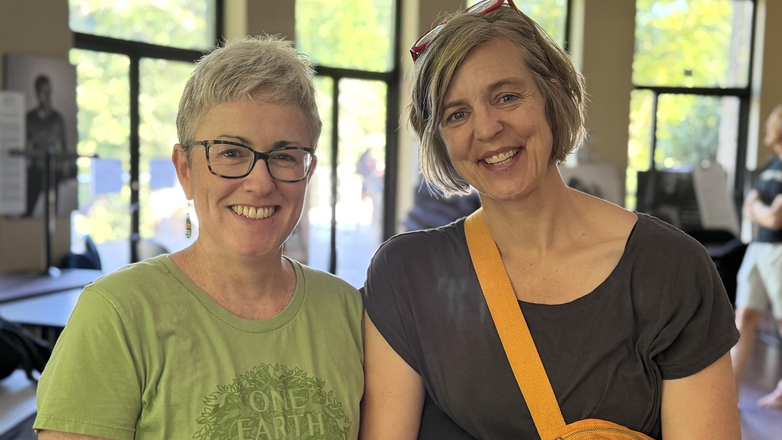 Two members of the sangha smiling together in the meditation hall after a Sunday sitting.